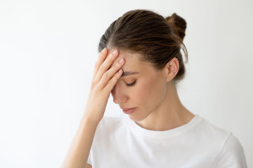 Woman holding head