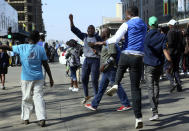 Protestors gather on the streets in Harare, Friday, Aug. 16, 2019. The main opposition Movement For Democratic Change party is holding protests over deteriorating economic conditions in the country as well as to try and force Zimbabwean President Emmerson Mnangagwa to set up a transitional authority to address the crisis and organize credible elections.(AP Photo/Tsvangirayi Mukwazhi)