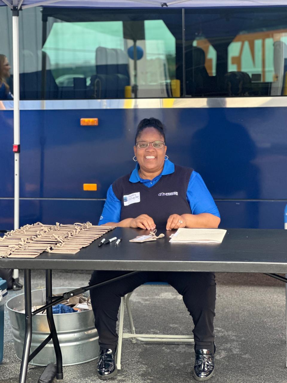 Premier Transportation – East Tennessee’s top-tier coach service, trusted by the UT Volunteers – recently hosted “Breakfast & Buses” at their company headquarters in North Knoxville. Here, driver Kristy Billingsby greets attendees. Aug. 15, 2023