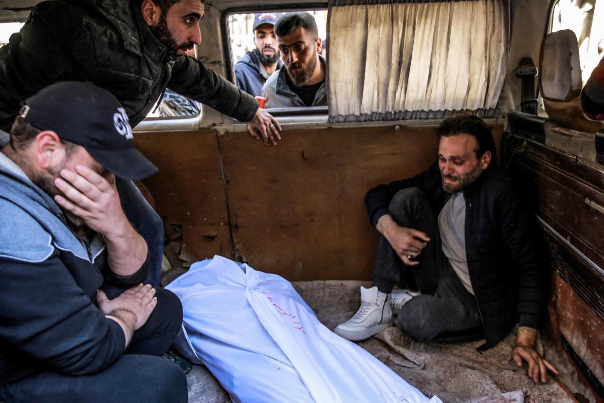 <span>People mourn at al-Shifa hospital in Gaza City after Israeli forces opened fire on crowds rushing at an aid distribution point on 29 February 2024.</span><span>Photograph: AFP via Getty Images</span>