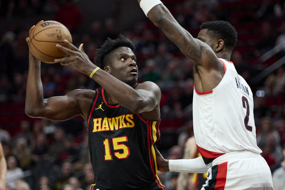 Atlanta Hawks center Clint Capela, left, shoots over Portland Trail Blazers center Deandre Ayton during the first half of an NBA basketball game in Portland, Ore., Wednesday, March 13, 2024. (AP Photo/Craig Mitchelldyer)