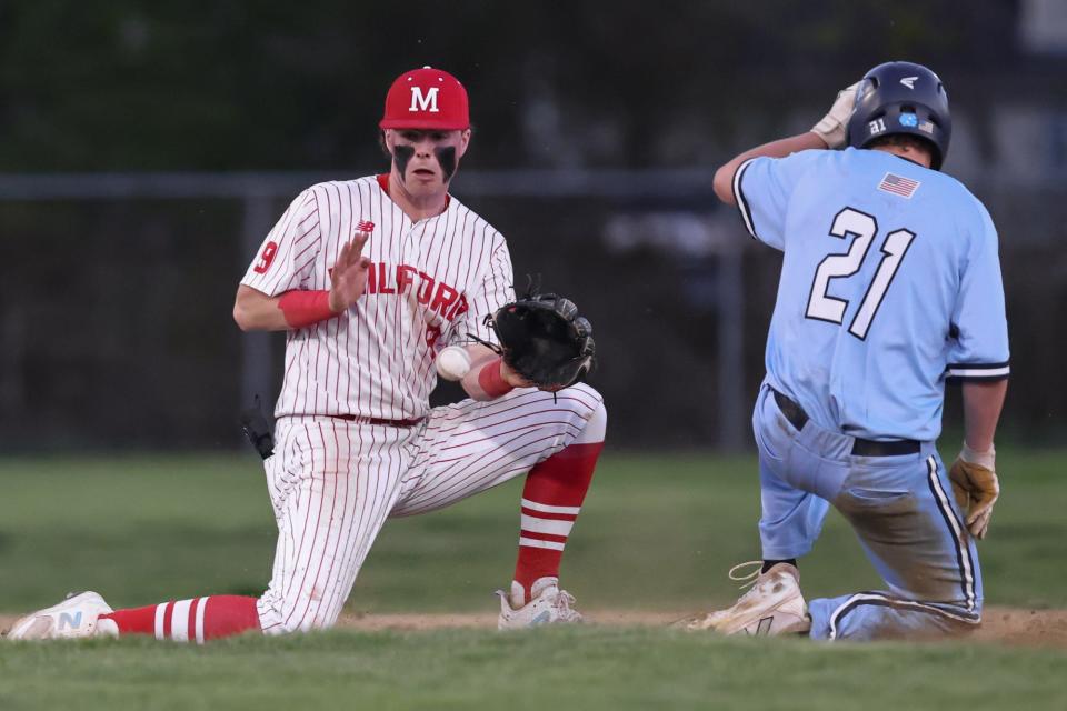 Milford sophomore Joey Mcgee tries to tag out Franklin senior captain Rex Cinelli during the baseball game at Fino Field in Milford on May 01, 2024.