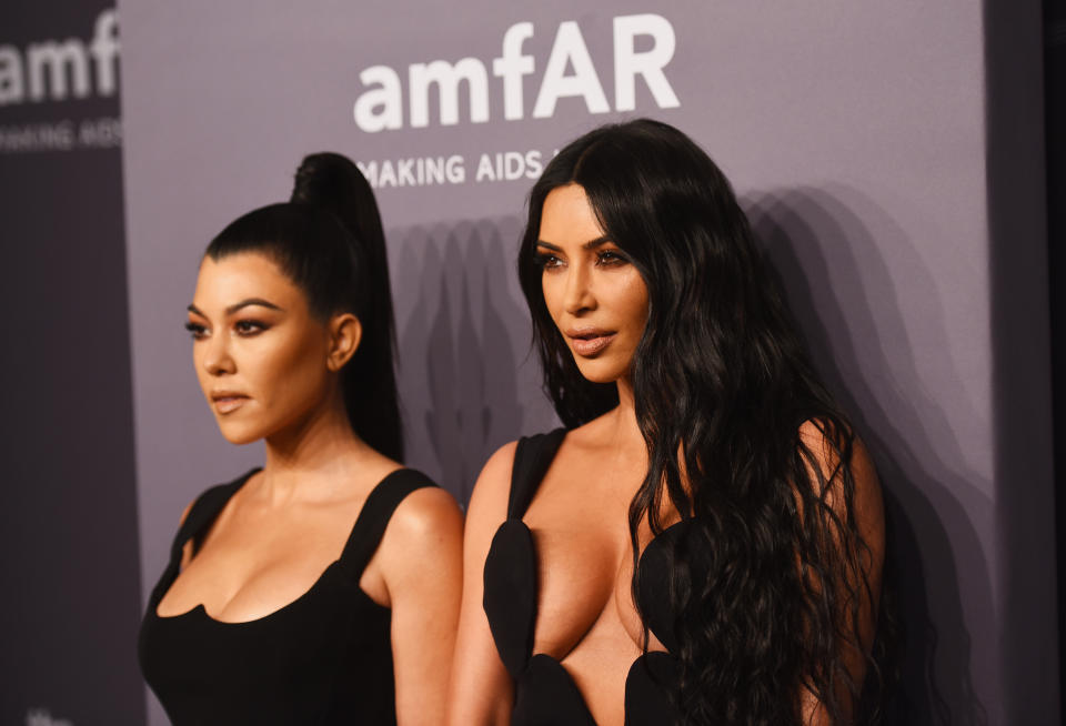 Kourtney Kardashian and Kim Kardashian attend the amfAR New York Gala. (Photo: Jared Siskin/amfAR via Getty Images)