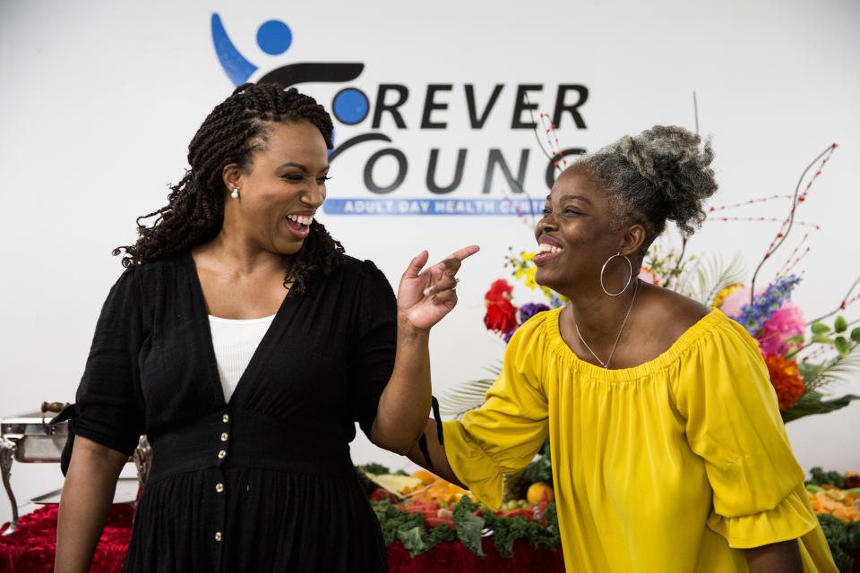 Ayanna Pressley, left, speaks with Haitian community member Marline Amedee on July 28. (Photo: Kayana Szymczak for Yahoo News)