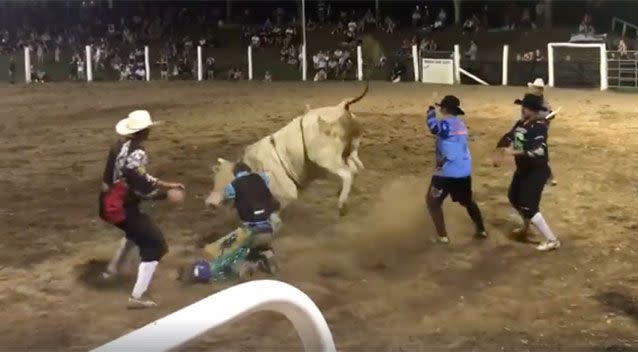 Danny Worth comes off the bull at the Wingham rodeo, his purple hemet ripped to the ground. Source: Danny Worth / Facebook