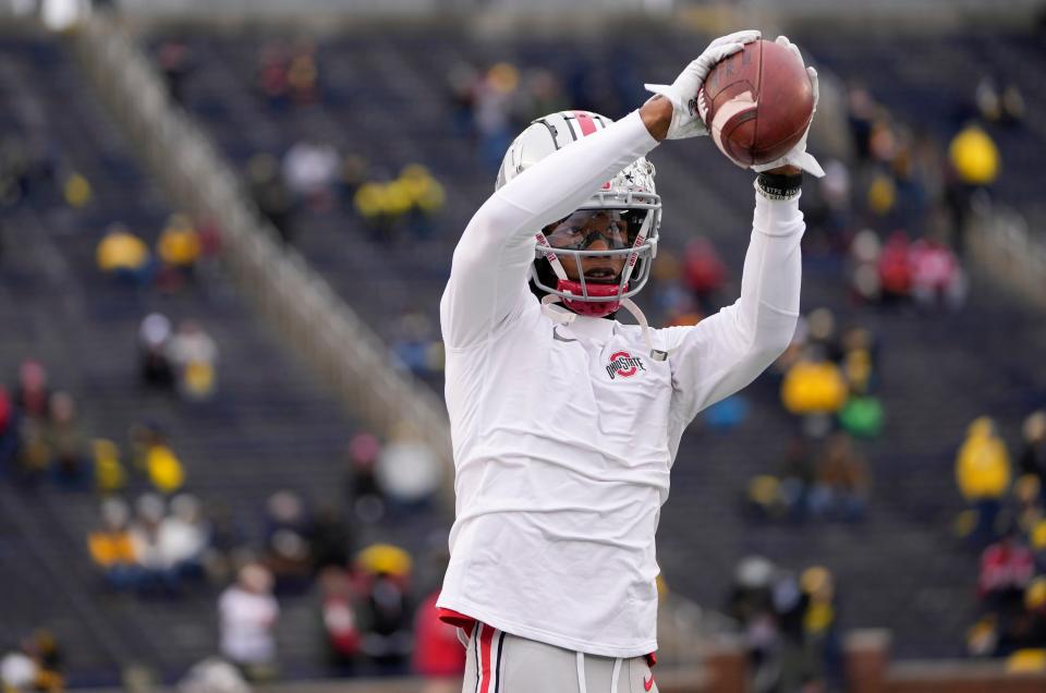 Ohio State Buckeyes wide receiver Garrett Wilson (5) warms up prior to the NCAA football game against the Michigan Wolverines at Michigan Stadium in Ann Arbor on Saturday, Nov. 27, 2021.