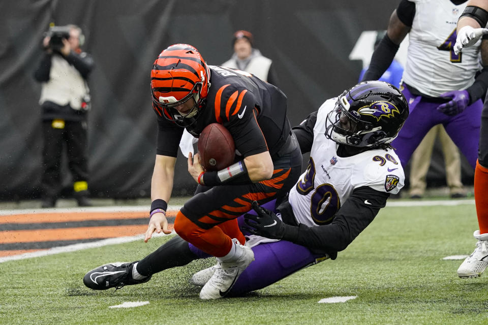 Cincinnati Bengals quarterback Joe Burrow (9) fumbles as his tackled by Baltimore Ravens linebacker David Ojabo (90) in the second half of an NFL football game in Cincinnati, Sunday, Jan. 8, 2023. (AP Photo/Joshua A. Bickel)