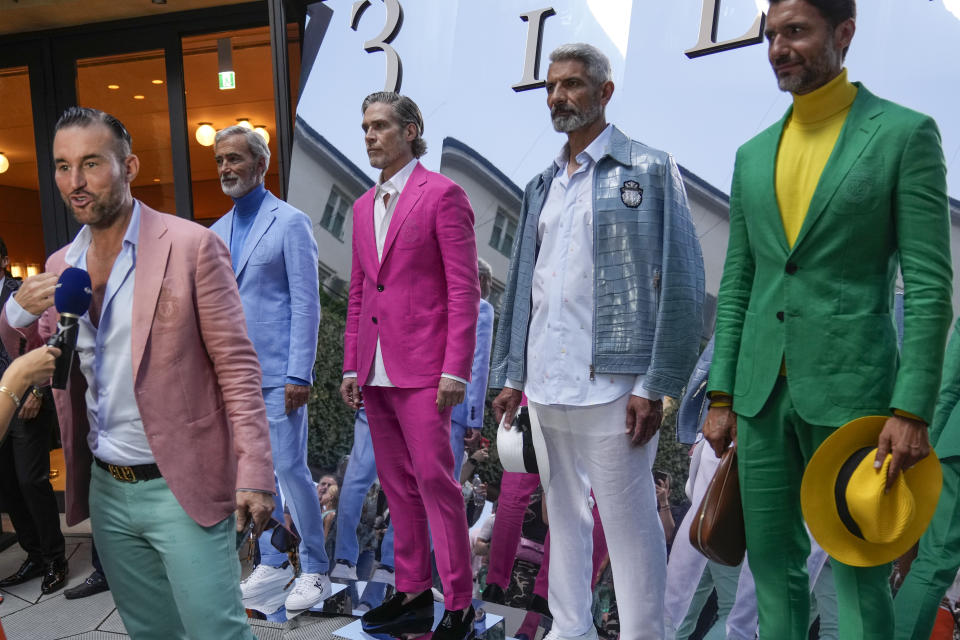 Philipp Plein is interviewed as he stands with models during the presentation of the Billionaire men's Spring Summer 2023 collection presented in Milan, Italy, Friday, June 17, 2022. (AP Photo/Luca Bruno)