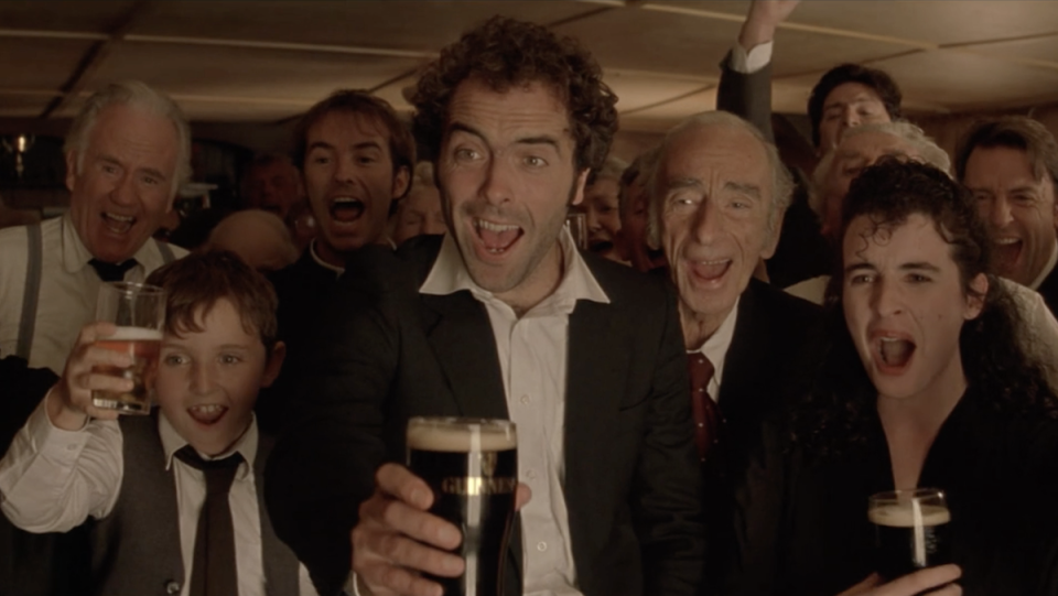 A crowded pub cheers in Waking Ned Devine