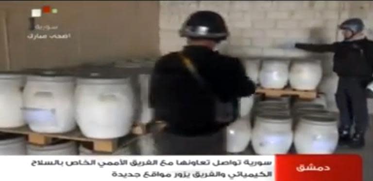 An image grab taken from Syrian television on October 19, 2013 shows an inspectors from the Organisation for the Prohibition of Chemical Weapons at work at an undisclosed location in Syria