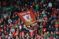 A banner praising the findings of a recent report into the Hillsborough disaster is unfurled in the crowd by Liverpool supporters before the Premier League match between Liverpool and Manchester United at Anfield in Liverpool. Robin van Persie's second-half penalty secured a 2-1 Premier League win for Manchester United over 10-man Liverpool at an emotionally-charged Anfield