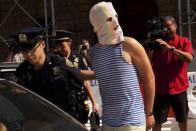 New York Police Department officers arrest a man demonstrating in solidarity with the Russian punk band Pussy Riot in front of the Russian Consulate in New York August 17, 2012.