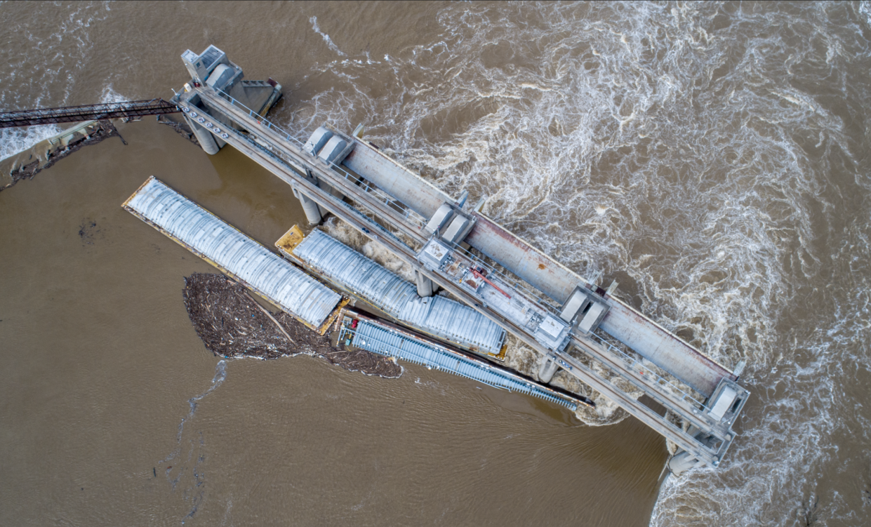 Barges against the dam just south of downtown Louisville on Tuesday, March 28, 2023