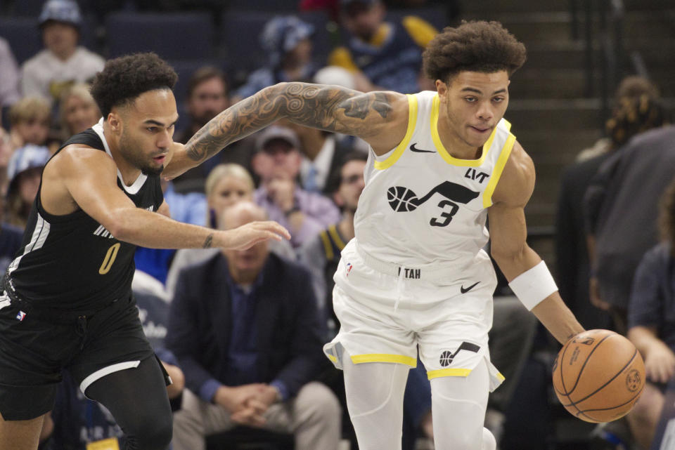 Utah Jazz guard Keyonte George (3) dribbles the ball while defended by Memphis Grizzlies guard Jacob Gilyard (0) during the first half of an NBA basketball in-season tournament game Friday, Nov. 10, 2023, in Memphis, Tenn. (AP Photo/Nikki Boertman)