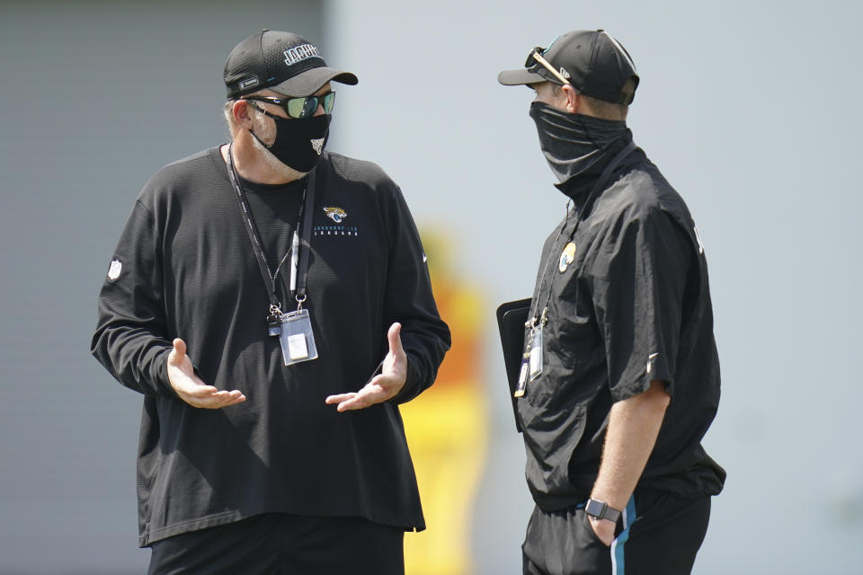 Jacksonville Jaguars head coach Doug Marrone, left, talks with Tad Dickman, director of public relations, during an NFL football workout, Wednesday, Aug. 12, 2020, in Jacksonville, Fla. (AP Photo/John Raoux)