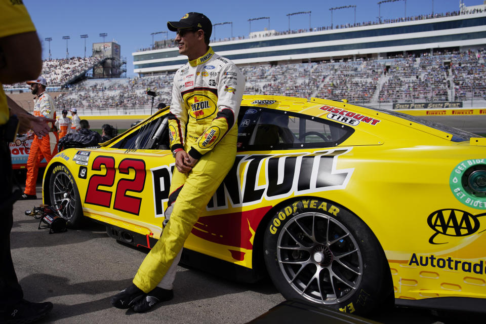 Joey Logano leans on his car before the start of a NASCAR Cup Series auto race Sunday, Oct. 16, 2022, in Las Vegas. (AP Photo/John Locher)