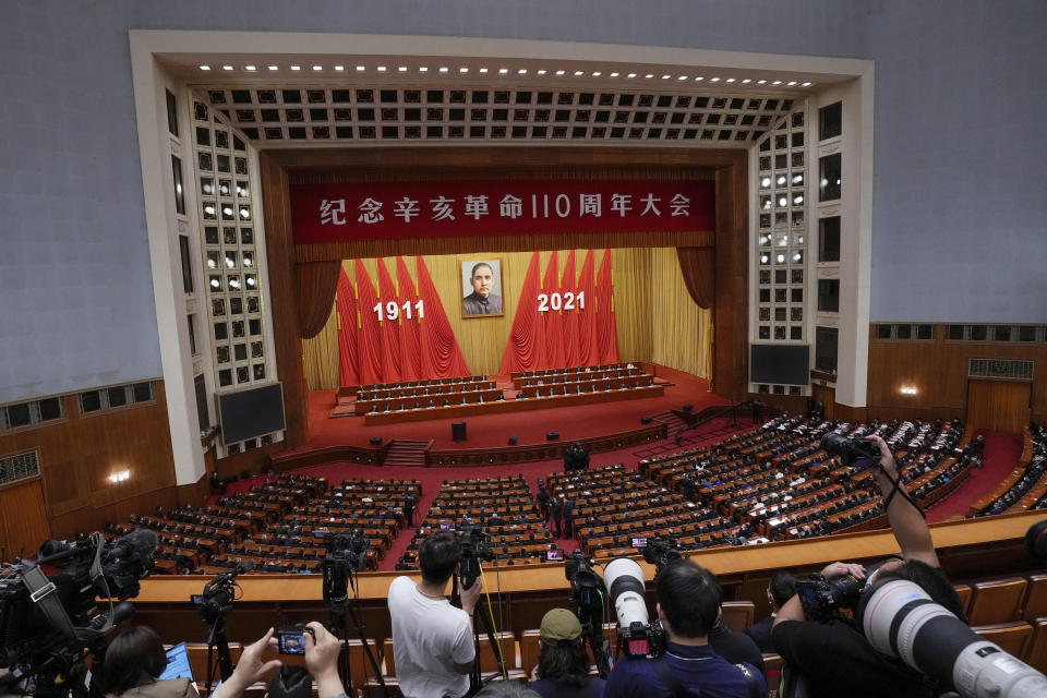 Journalists film Chinese President Xi Jinping as he delivers a speech at an event commemorating the 110th anniversary of Xinhai Revolution at the Great Hall of the People in Beijing, Saturday, Oct. 9, 2021. (AP Photo/Andy Wong)