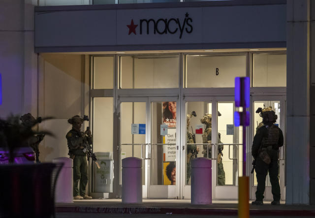 Police officers stand guard at an entrance of a shopping mall, Wednesday, Feb. 15, 2023, in El Paso, Texas. Police say one person was killed and three other people were wounded in a shooting at Cielo Vista Mall. One person has been taken into custody, El Paso police spokesperson Sgt. Robert Gomez said. (AP Photo/Andrés Leighton)