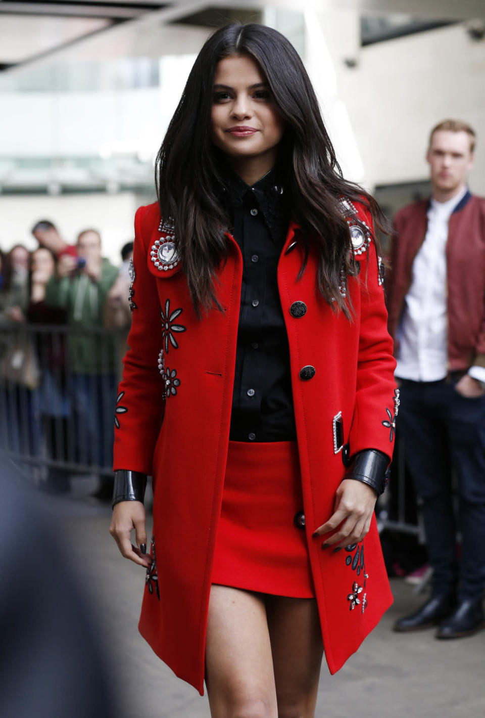 Finally, she changed into a matching pillar-box red two-piece, featuring a long red jacket with floral embellishments and paired it with a matching mini skirt and black button down blouse. [Photo: Getty]