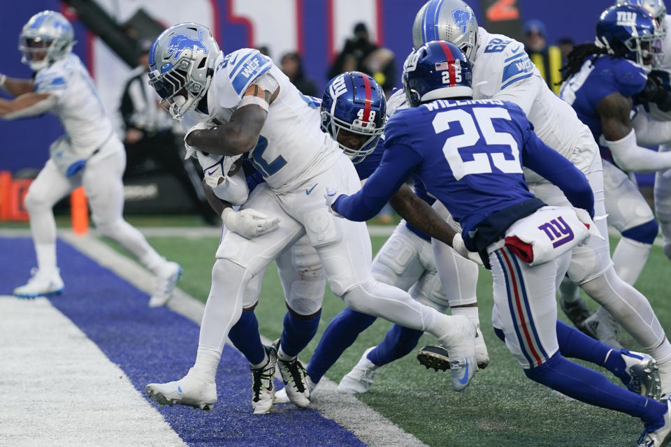 Detroit Lions running back D'Andre Swift (32) runs in a touchdown against New York Giants linebacker Tae Crowder (48) during the second half of an NFL football game, Sunday, Nov. 20, 2022, in East Rutherford, N.J. (AP Photo/Seth Wenig)