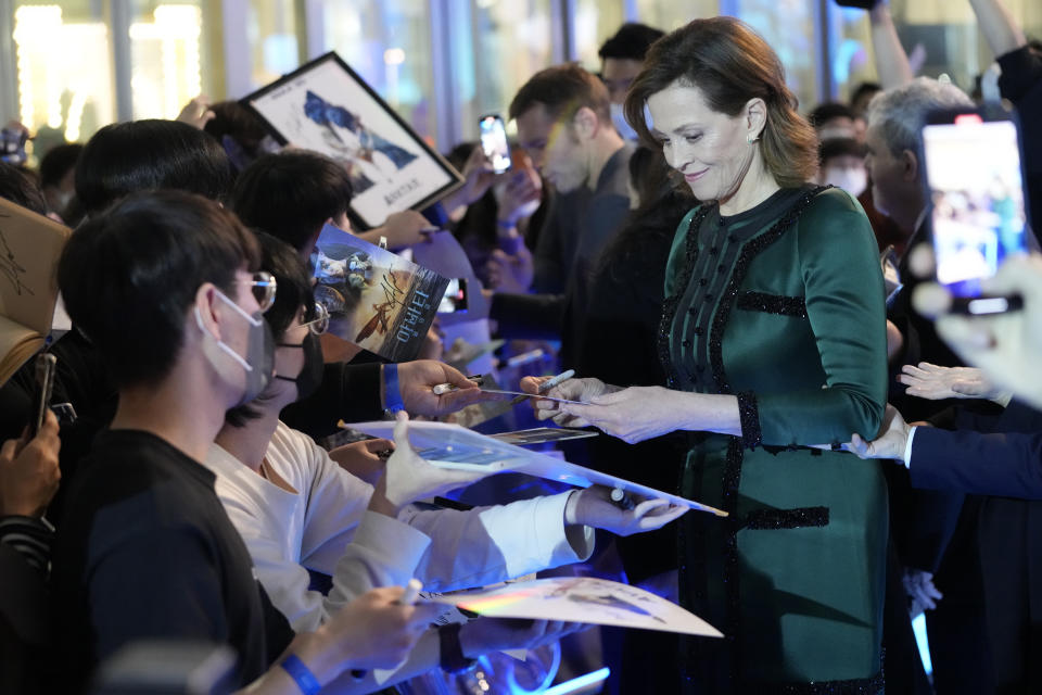 Sigourney Weaver signs an autograph for fans during the blue carpet event to promote her latest movie 'Avatar: The Way of Water' in Seoul, South Korea, Friday, Dec. 9, 2022. The movie is to be released in the country on Dec. 14. (AP Photo/Ahn Young-joon)