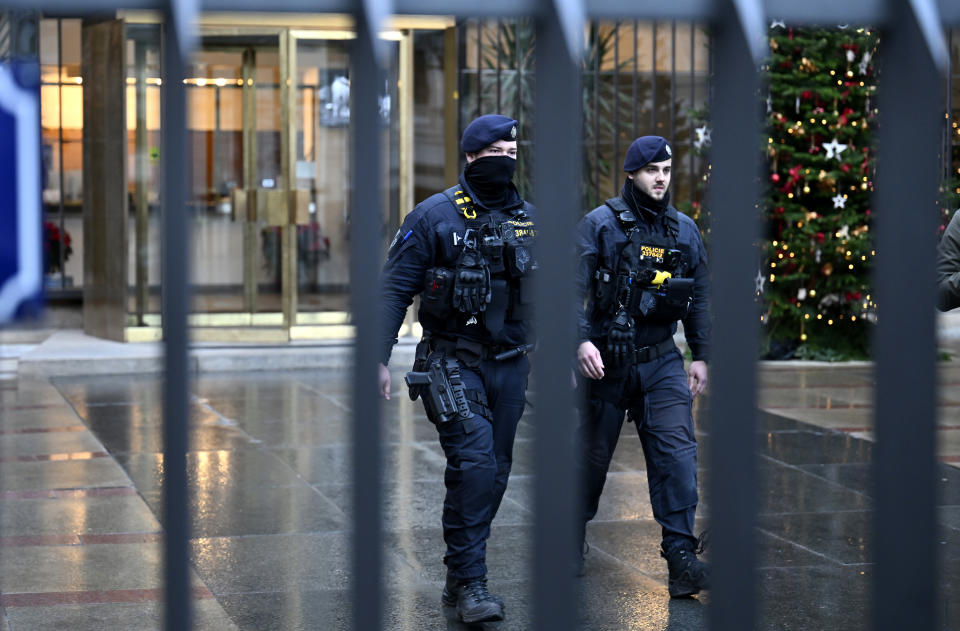 Policemen walk outside the headquarters of Charles University following mass shooting in Prague, Czech Republic, Friday, Dec. 22, 2023. A lone gunman opened fire at a university on Thursday, killing more than a dozen people and injuring scores of people. (AP Photo/Denes Erdos)