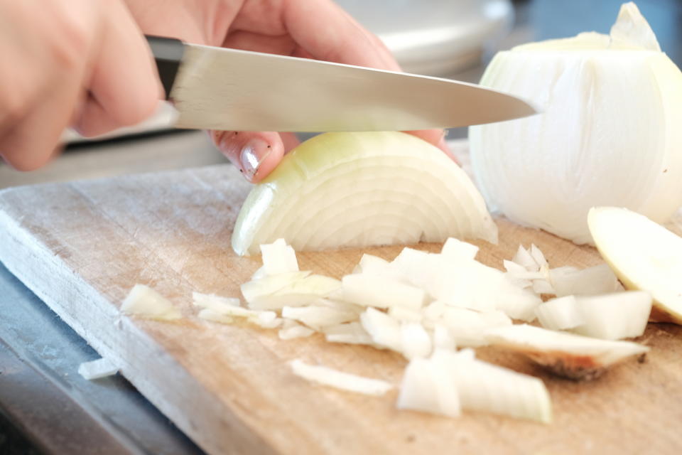 chopping onion on cutting board