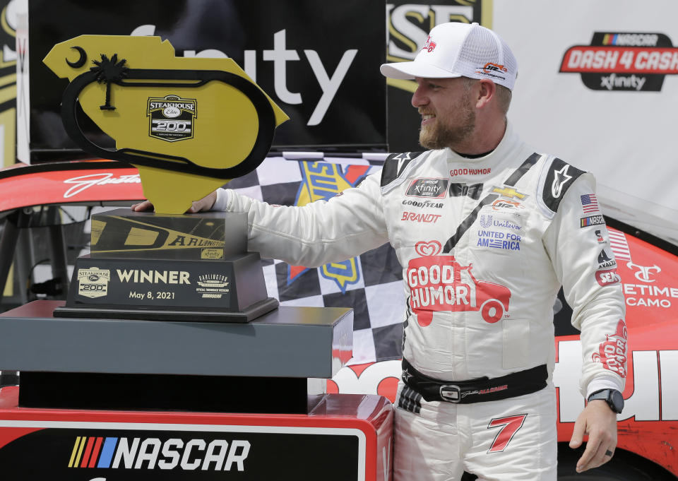 Justin Allgaier poses with the trophy in Victory Lane after winning the NASCAR Xfinity Series auto race at Darlington Raceway, Saturday, May 8, 2021, in Darlington, S.C. (AP Photo/Terry Renna)