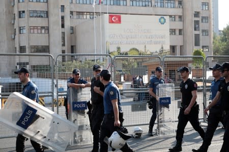 Turkish police walk in front of the Metropolitan Municipality headquarters in Diyarbakir