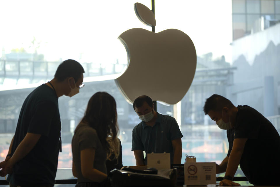 Customers shop at an Apple Store on the first day of sale for the Apple iPhone 14 in Beijing, China, Friday, Sept. 16, 2022. (AP Photo/Mark Schiefelbein)