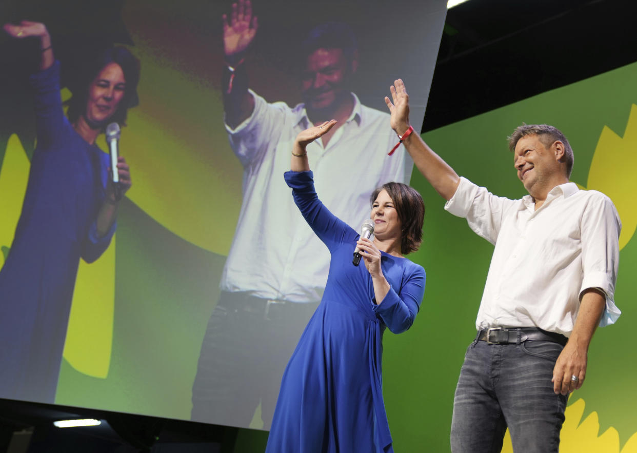 Annalena Baerbock, left, candidate for chancellor and federal leader of the Green party and Robert Habeck, federal leader, take the stage at the election party in Berlin, Sunday, Sept. 26, 2021. Exit polls show the center-left Social Democrats in a very close race with outgoing Chancellor Angela Merkel’s bloc in Germany’s parliamentary election, which will determine who succeeds the longtime leader after 16 years in power.  (Kay Nietfeld/dpa via AP)