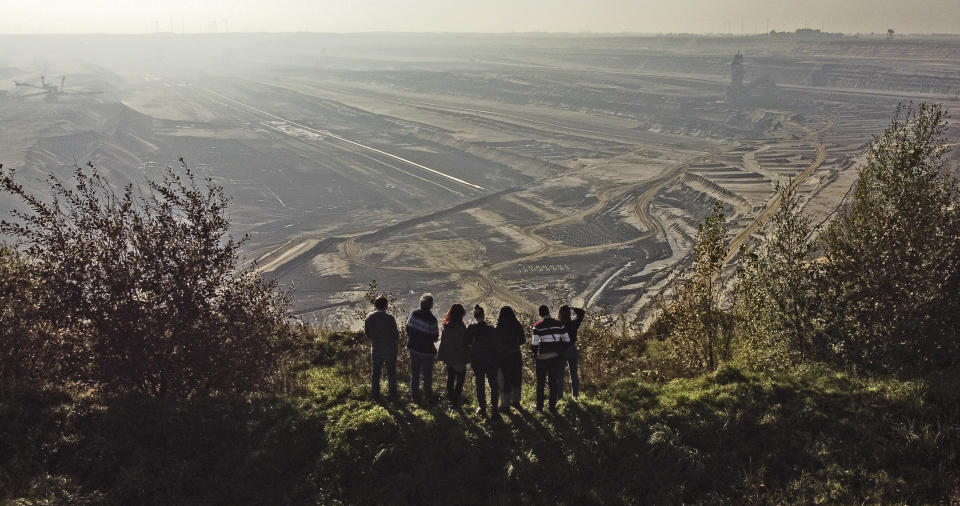 Climate activists including Vanessa Nakate from Uganda and Leonie Bremer of the German Fridays for Future movement, visit the Garzweiler open-cast coal mine in Luetzerath, western Germany, Saturday, Oct. 9, 2021. Garzweiler, operated by utility giant RWE, has become a focus of protests by people who want Germany to stop extracting and burning coal as soon as possible. (AP Photo/Martin Meissner)