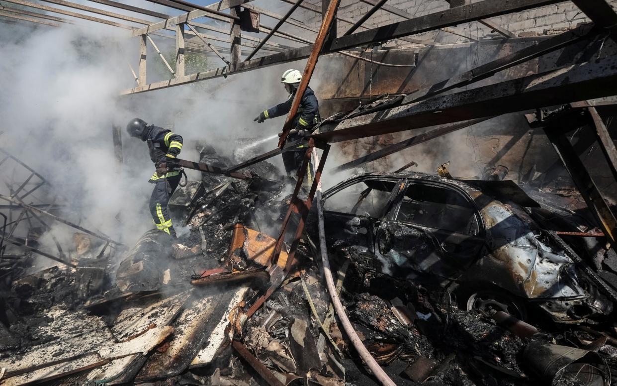 Rescuers work at a site of a Russian missile strike, amid Russia's attack on Ukraine