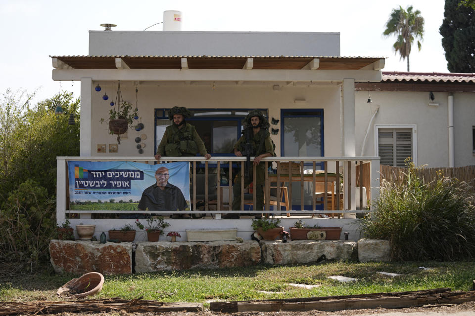 CORRECTS DAY TO SATURDAY - Israeli soldiers deploy in kibbutz Kfar Azza on Tuesday, Oct. 10, 2023. Hamas militants overran Kfar Azza on Saturday, where many Israelis were killed and taken captive. (AP Photo/Ohad Zwigenberg)