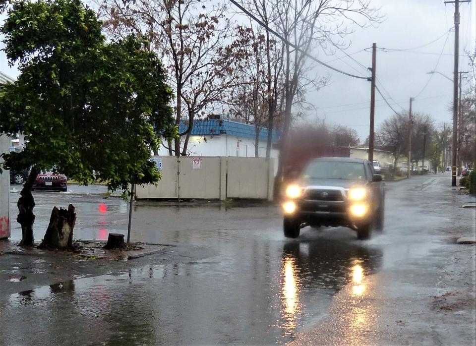 A truck goes through standing water in an alley in downtown Redding on Wednesday, Jan. 4, 2023. Weather forecasters predicted 3 to 4 inches of rain to fall over the North State on Wednesday and Thursday.