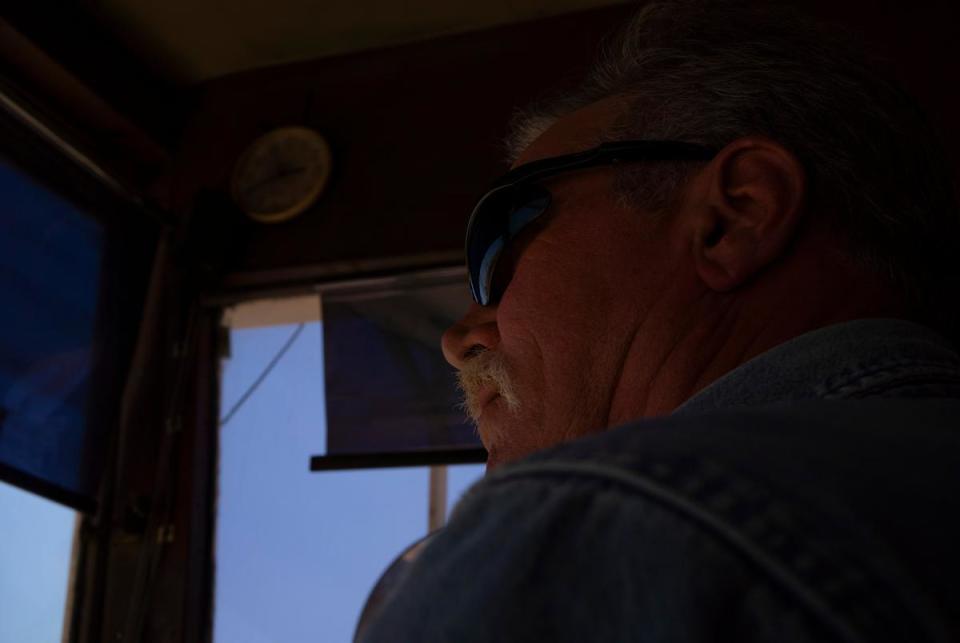 Mark Payne, 62, the dragline operator, excavates and moves tons of dirt in the process of environmental reclamation at the NRG Jewett Mine in Jewett on June 29, 2023. Payne has been working at the mine for 37 years, and has been operating the dragline for 17 years. “We’ve been here, in this part of the mine, just trying to fill this hole for almost a year,” Payne said. “It takes quite a long time.”