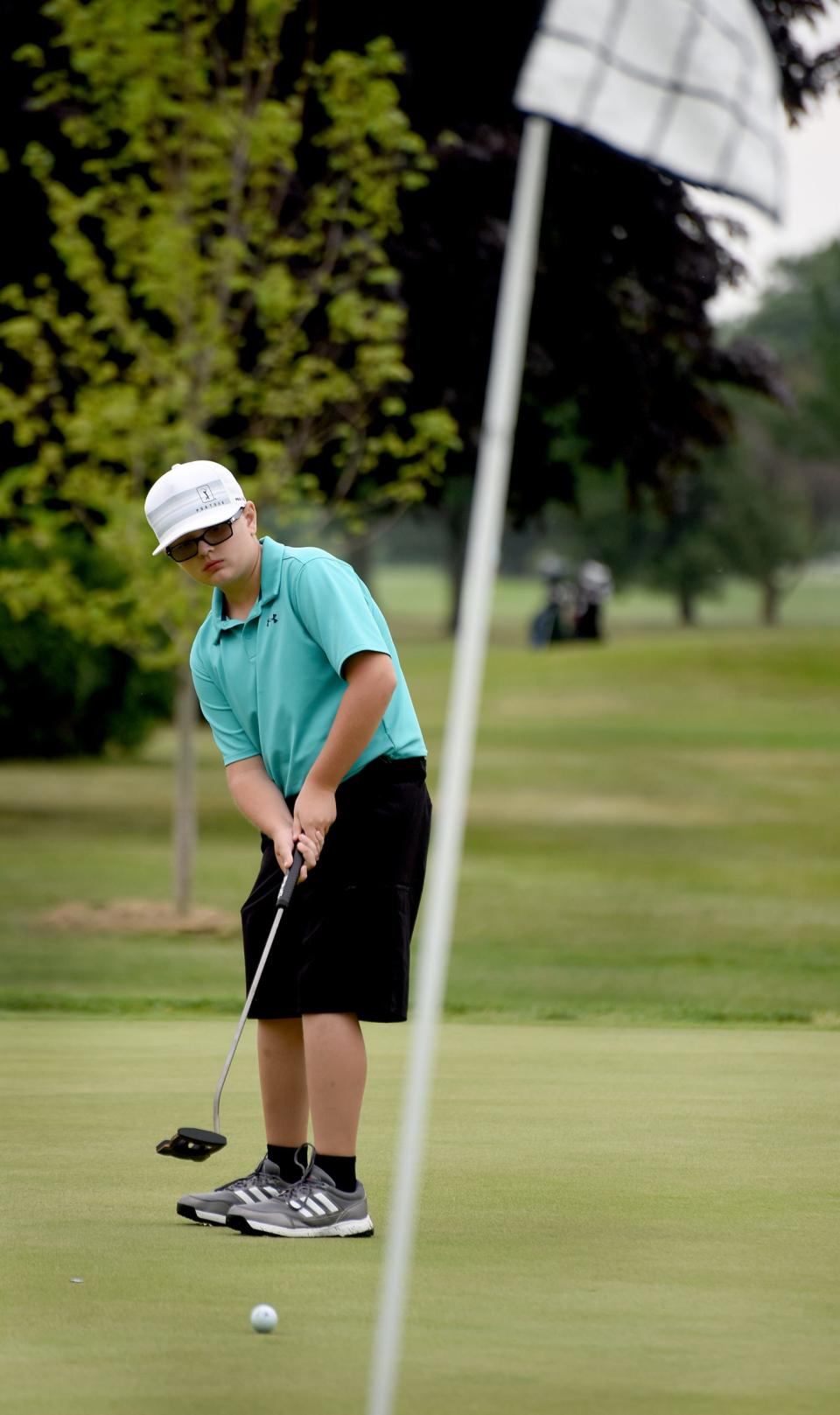 Liam Doll of Tecumseh attempts a birdie putt in the 44th annual La-Z-Boy Junior Open on Wednesday at Green Meadows.