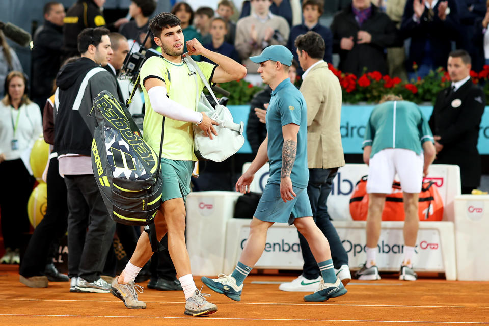 Carlos Alcaraz walks off court.