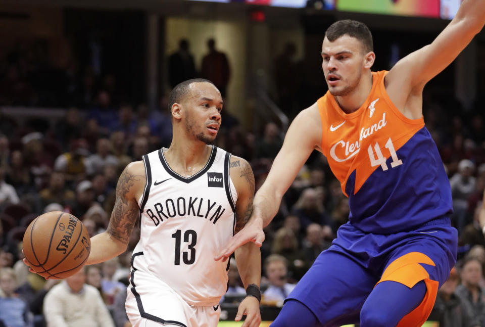 Brooklyn Nets' Shabazz Napier (13) drives past Cleveland Cavaliers' Ante Zizic (41), from Croatia, in the first half of an NBA basketball game, Wednesday, Feb. 13, 2019, in Cleveland. (AP Photo/Tony Dejak)