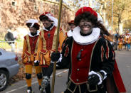 "Zwarte Piet" (Black Pete), who are a Saint Nicholas' assistants are seen during a traditional parade in Amsterdam, Netherlands, November 18, 2018. REUTERS/Eva Plevier