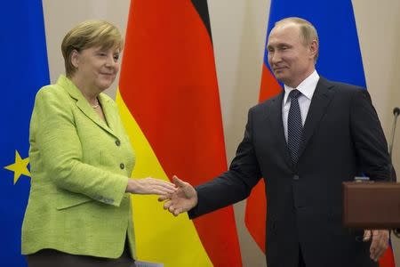 Russian President Vladimir Putin and German Chancellor Angela Merkel shake hands during a joint news conference following their talks at the Bocharov Ruchei state residence in Sochi, Russia, May 2, 2017. REUTERS/Alexander Zemlianichenko/Pool