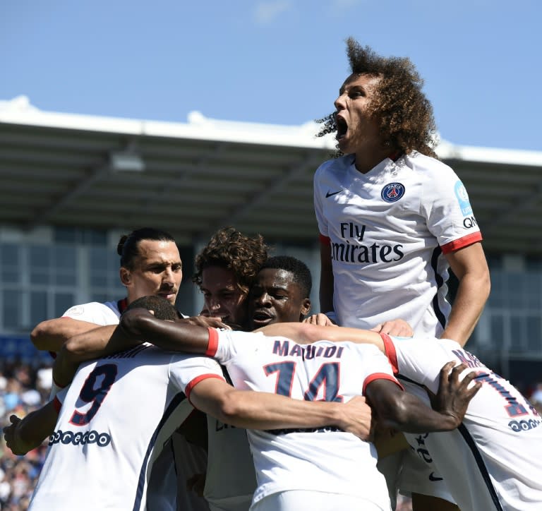 Paris Saint-Germain's Uruguayan forward Edinson Cavani is congratulated by teammates during the French Trophy of Champions football match against Lyon at Saputo stadium in Montreal on August 1, 2015