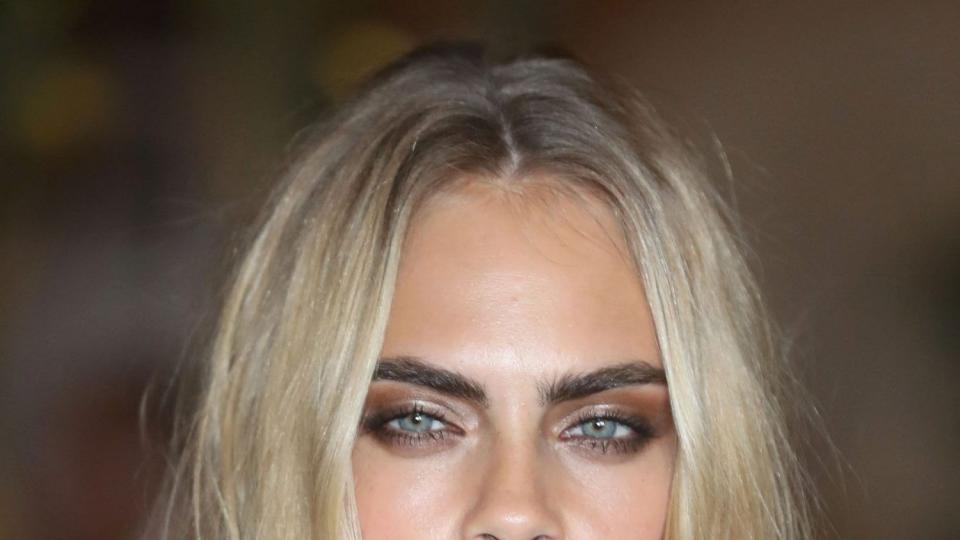 Cara Delevingne attends fashion week with ashy, blonde hair