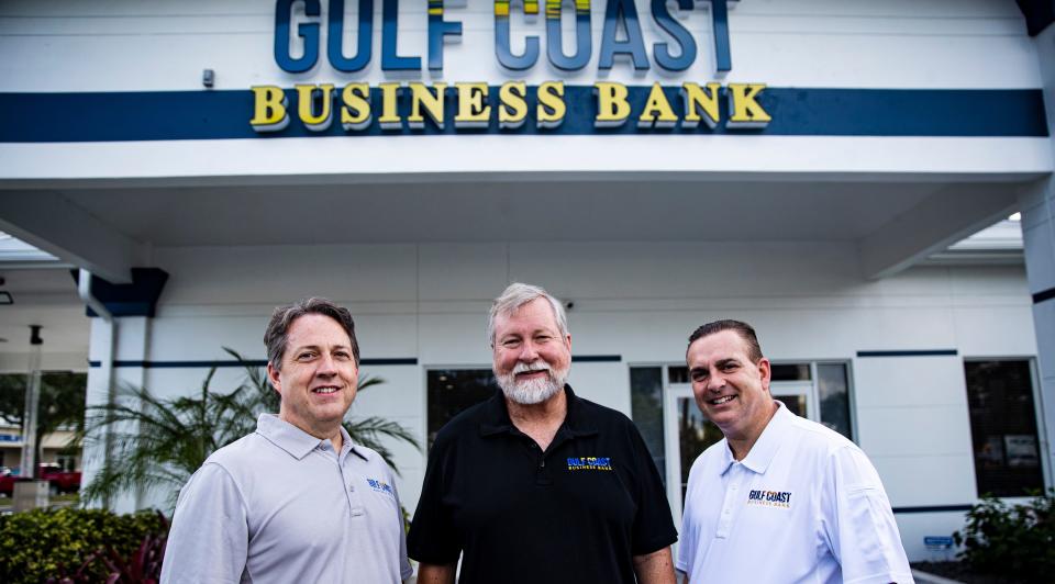 From left, Stacy Suddeth, senior credit officer, Guy Harris, chief financial officer and Tom Robinson, senior commercial lender stand for a portrait in front of the new  Gulf Coast Business Bank at the intersection of Metro Parkway Crystal Drive works on Friday.  