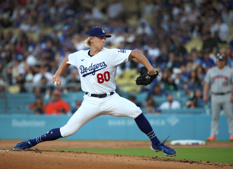 Dodgers starter Emmet Sheehan stretches on the mound and delivers a pitch.