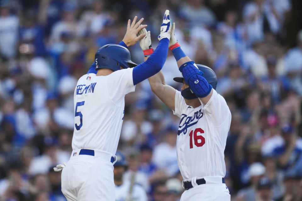 Los Angeles Dodgers' Freddie Freeman (5) and Will Smith (16) celebrate after they both scored off of a home run hit by Smith during the eighth inning of a baseball game against the Houston Astros in Los Angeles, Sunday, June 25, 2023. (AP Photo/Ashley Landis)