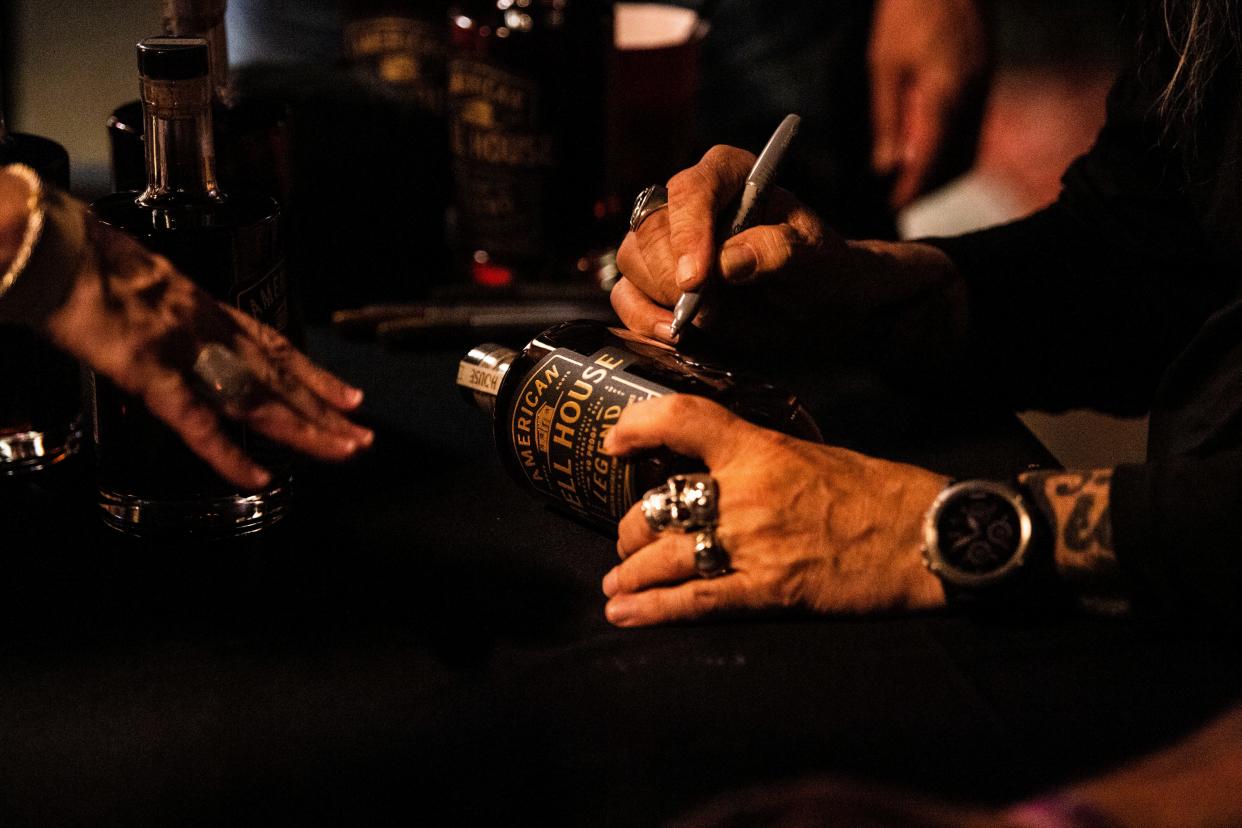 Rickey Medlocke and Johnny Van Zant sign bottles of their Hell House Whiskey at Nashville Palace in Nashville , Tenn., Friday, Dec. 29, 2023.