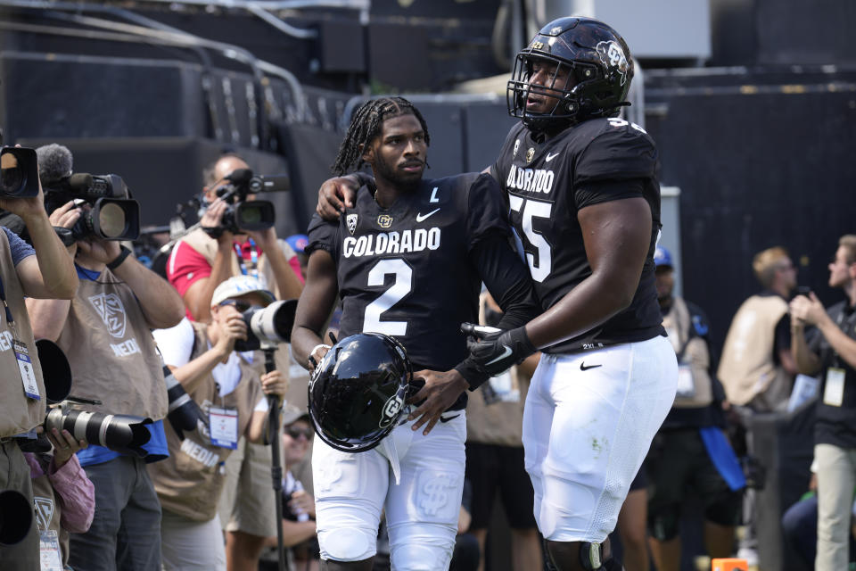 Colorado center Van Wells, right, celebrates with quarterback Shedeur Sanders after a touchdown in the second half of an NCAA college football game against Nebraska Saturday, Sept. 9, 2023, in Boulder, Colo. (AP Photo/David Zalubowski)