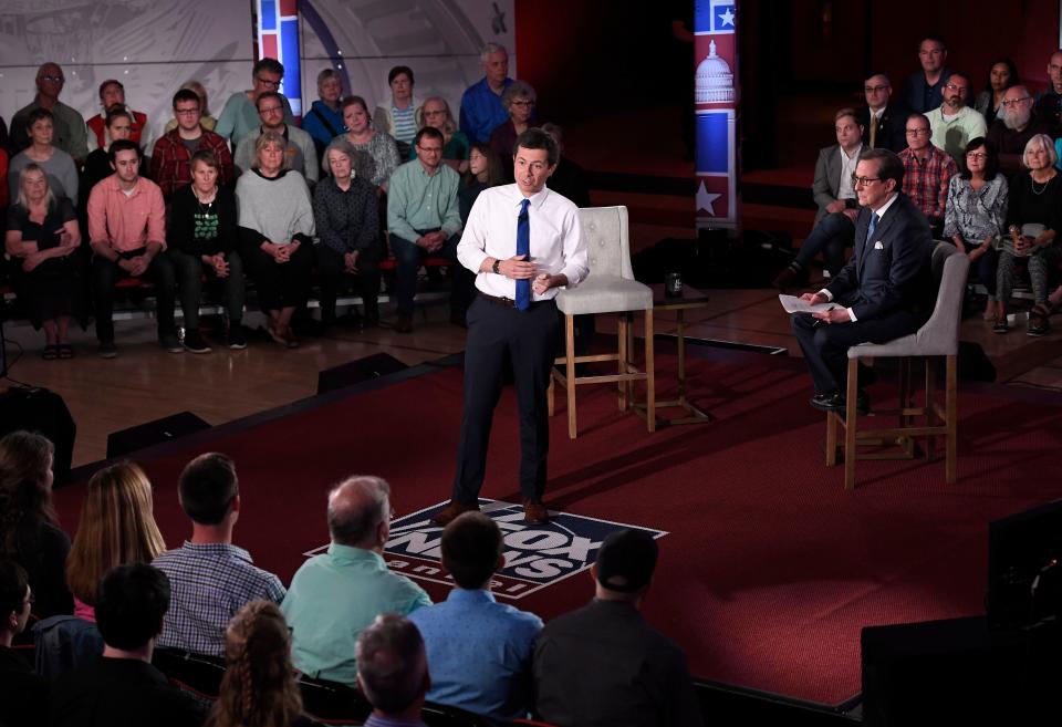 Democratic presidential candidate South Bend, Ind., Mayor Pete Buttigieg, center, answers a question during a FOX News Channel Town Hall moderated by Chris Wallace, center right, Sunday, May 19, 2019, in Claremont, N.H.