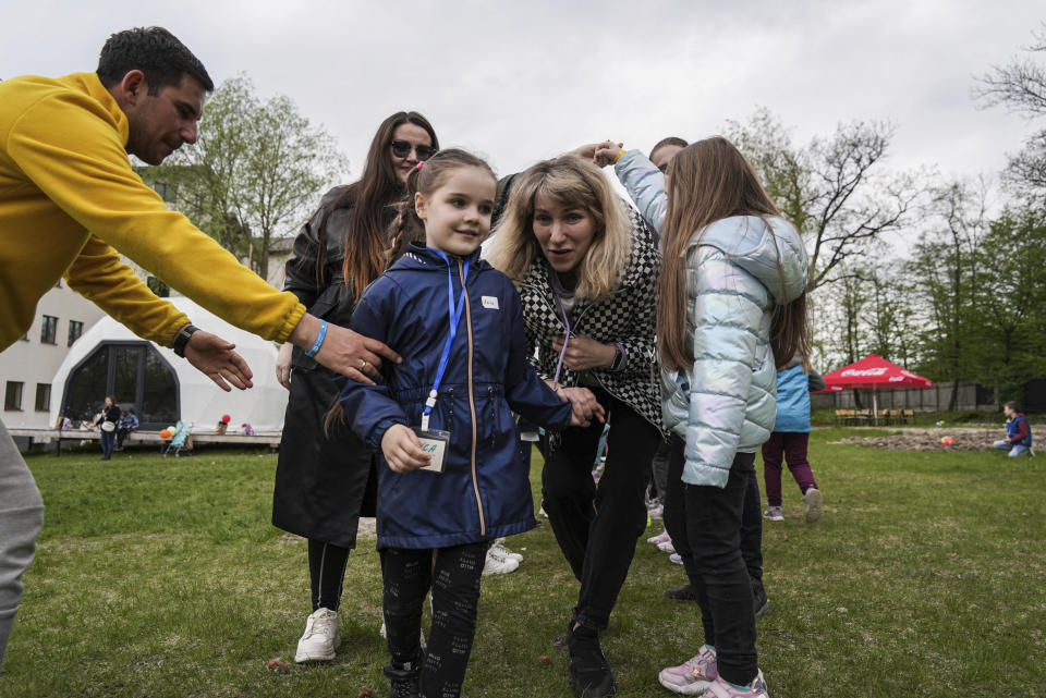 Children play at the recovery camp for children and their mothers affected by the war near Lviv, Ukraine, Wednesday, May 3, 2023. A generation of Ukrainian children have seen their lives upended by Russia's invasion of their country. Hundreds of kids have been killed. For the survivors, the wide-ranging trauma is certain to leave psychological scars that will follow them into adolescence and adulthood. UNICEF says an estimated 1.5 million Ukrainian children are at risk of mental health issues. (AP Photo/Vasilisa Stepanenko)